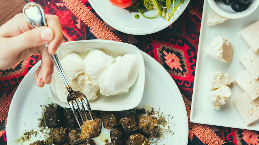 Dolma and cheese on a traditional Azerbaijani carpet spread